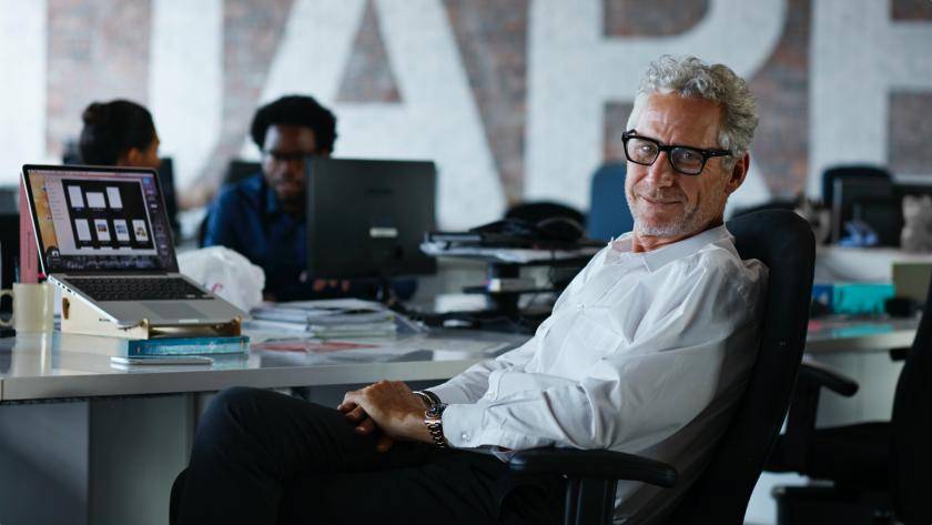 Man at desk smiling