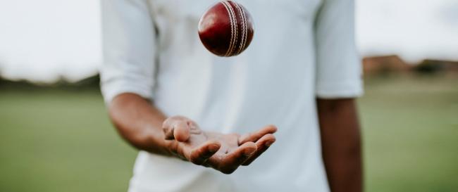 Cricket ball in mid-air in front of body